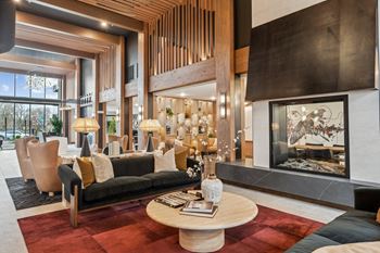 A modern living room with a fireplace and a large window.